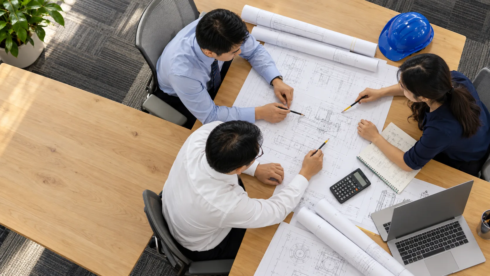 Colleagues reviewing engineering drawings together