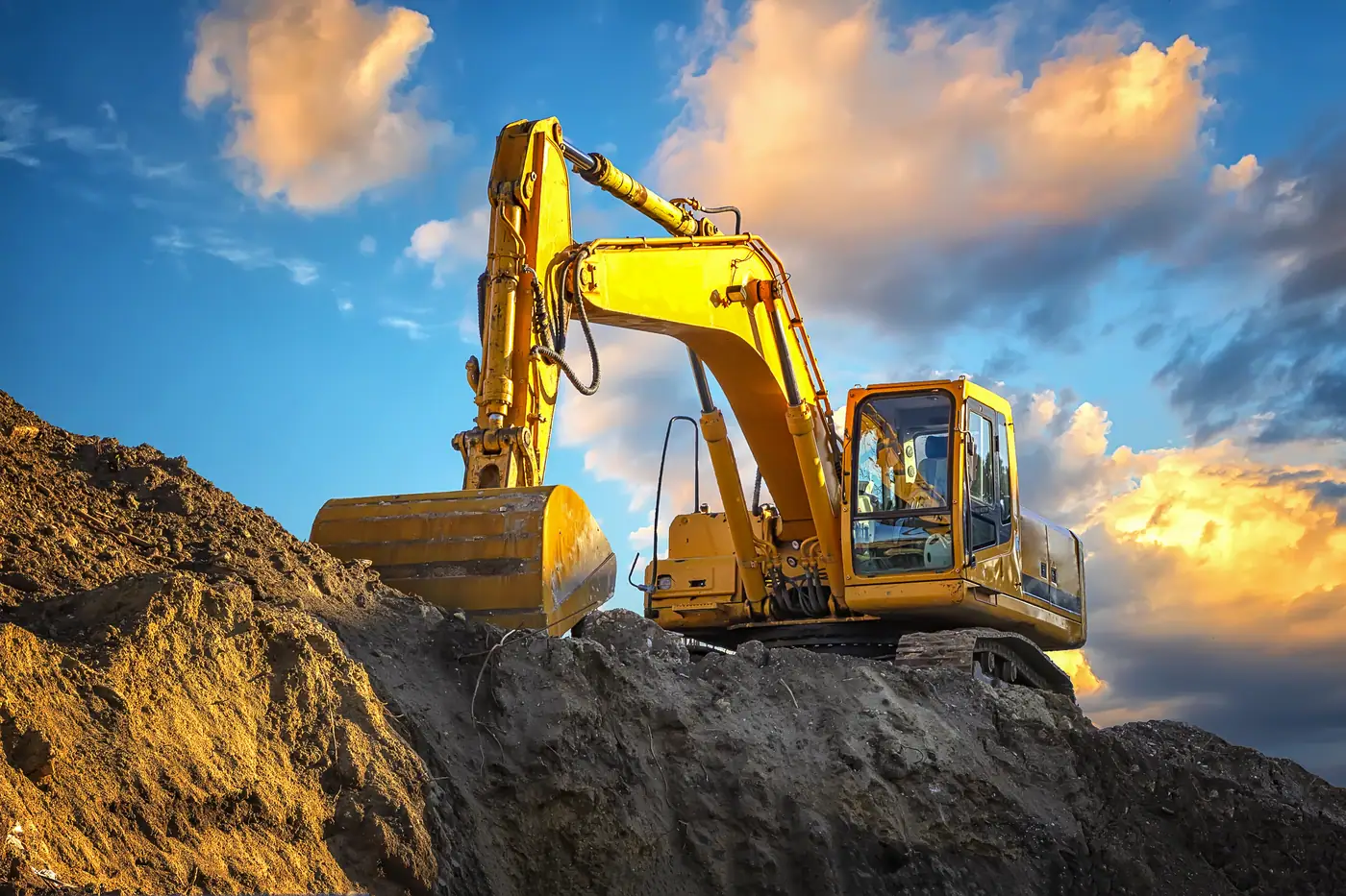 Excavator at work at sunset