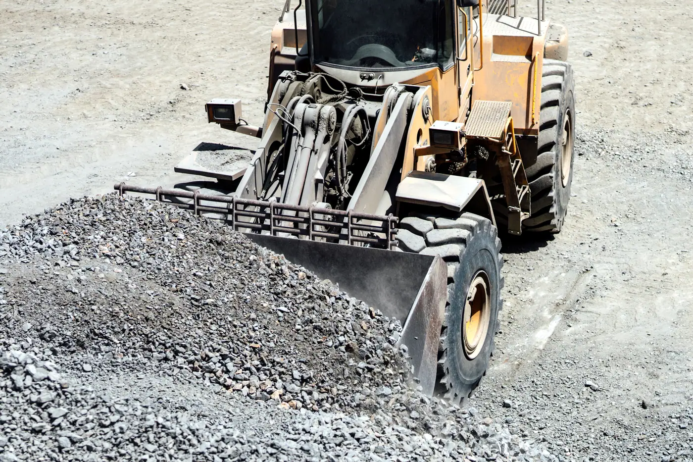 Heavy equipment loader working on gravel