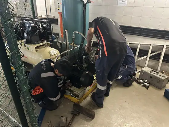 INNEOVA technicians servicing an air compressor