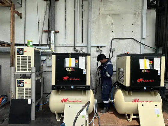 INNEOVA technicians servicing an air compressor
