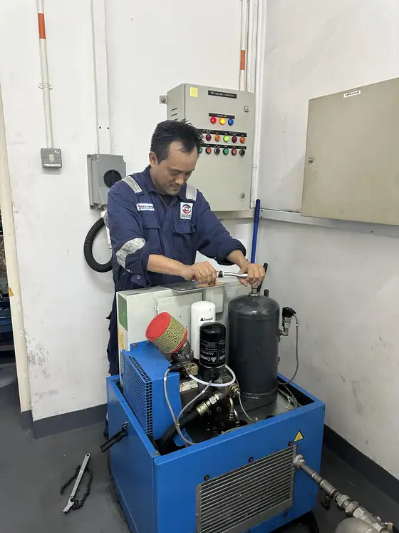INNEOVA technicians servicing an air compressor