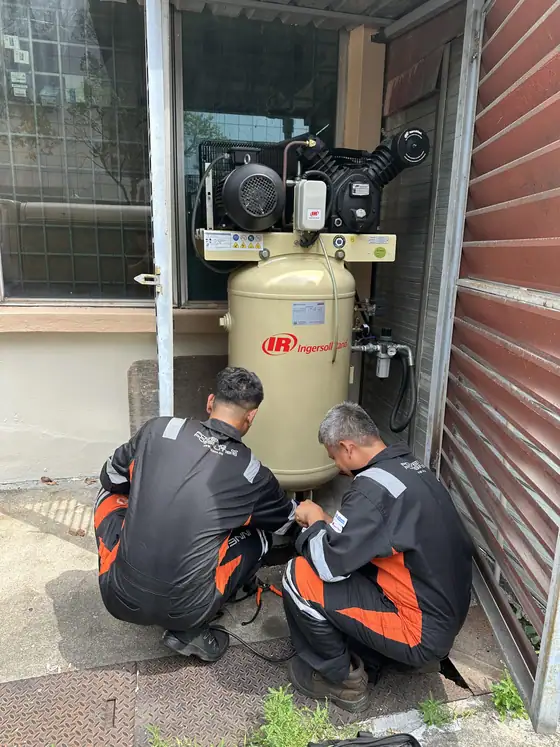 INNEOVA technicians servicing an air compressor