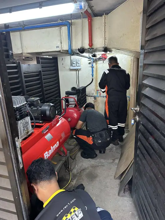 INNEOVA technicians servicing an air compressor