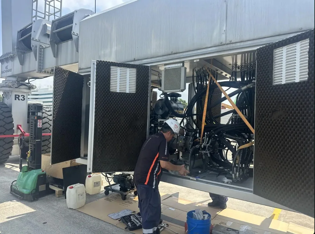 INNEOVA technician servicing a rubber-tyred gantry crane