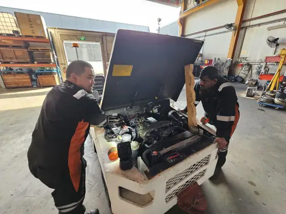 Technicians repairing a power unit in the workshop
