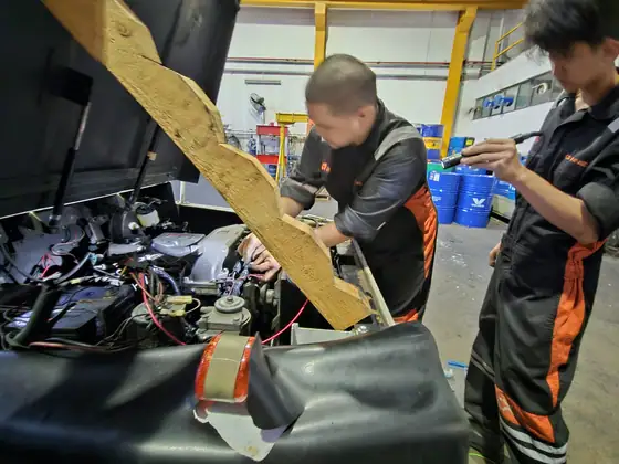 Technicians repairing a power unit in the workshop