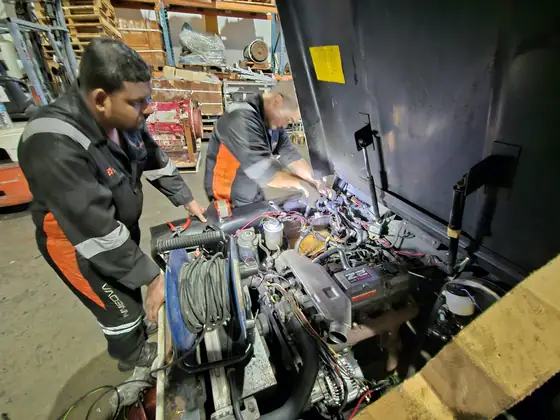 Technicians repairing a power unit in the workshop