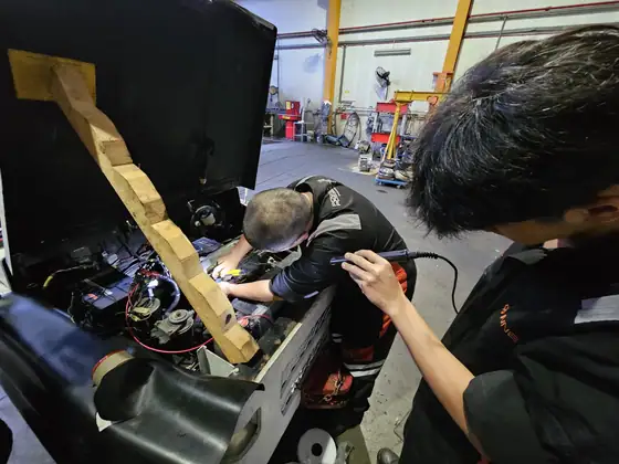 Technicians repairing a power unit in the workshop