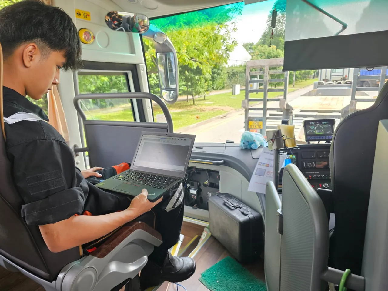 INNEOVA technician using a laptop for on-site bus diagnostics